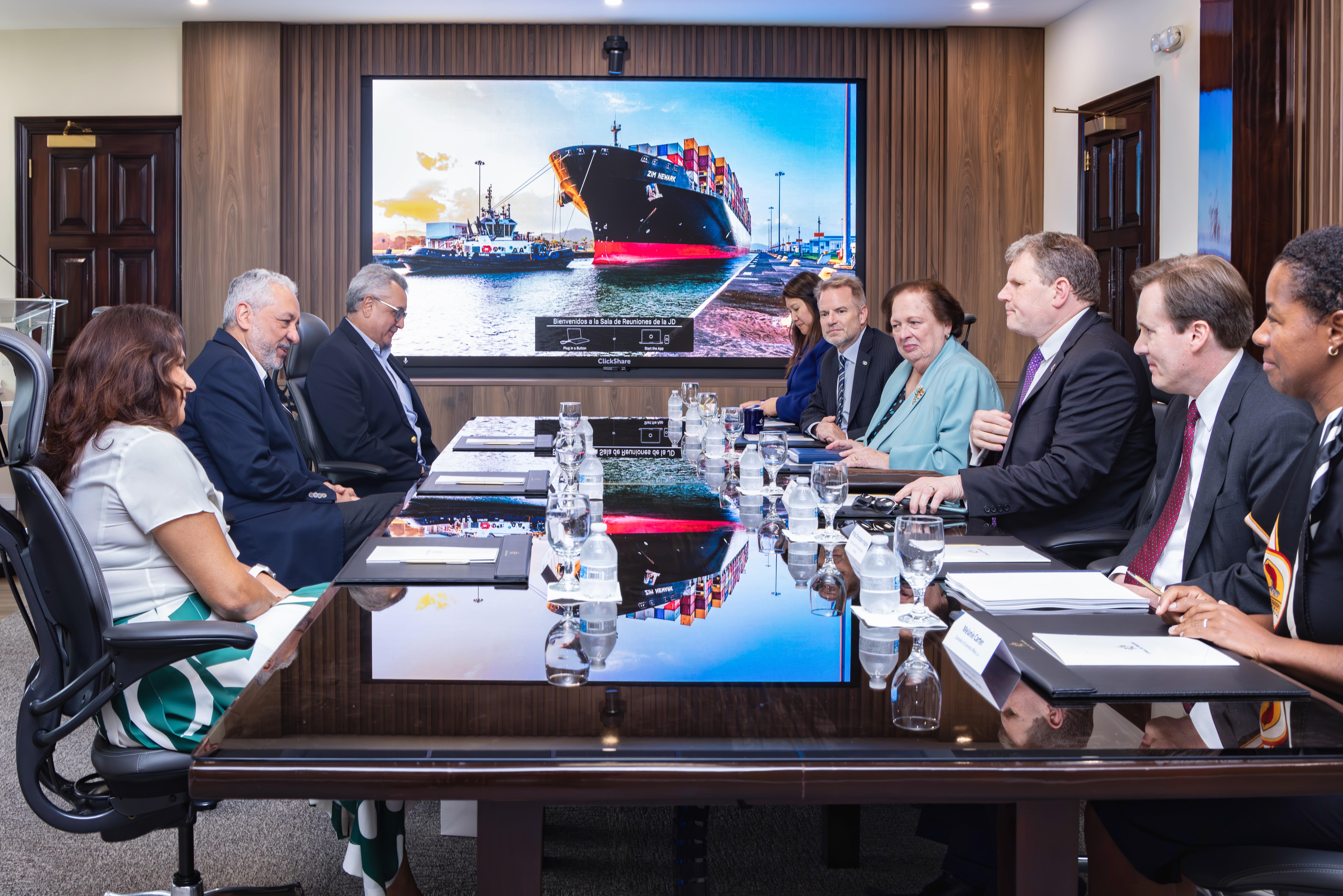 multiple people sitting around a conference table