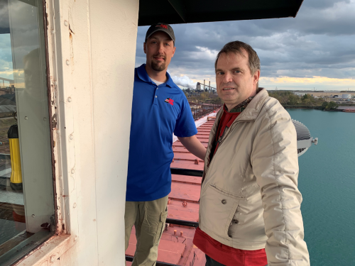 Commissioner Louis Sola (right) on the bridge of the MV Burns Harbor.