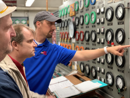 Commissioner Sola (center) in the engine room of the MV Burns Harbor.