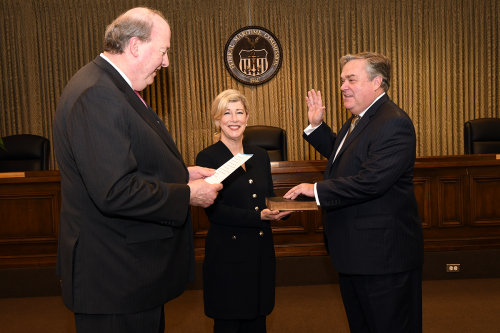 Suzanne Bentzel (center) holds the Bible while husband Carl Bentzel (right) is sworn-in as a Commissioner by Michael Khouri (left), Washington, D.C., December 9, 2019. 
